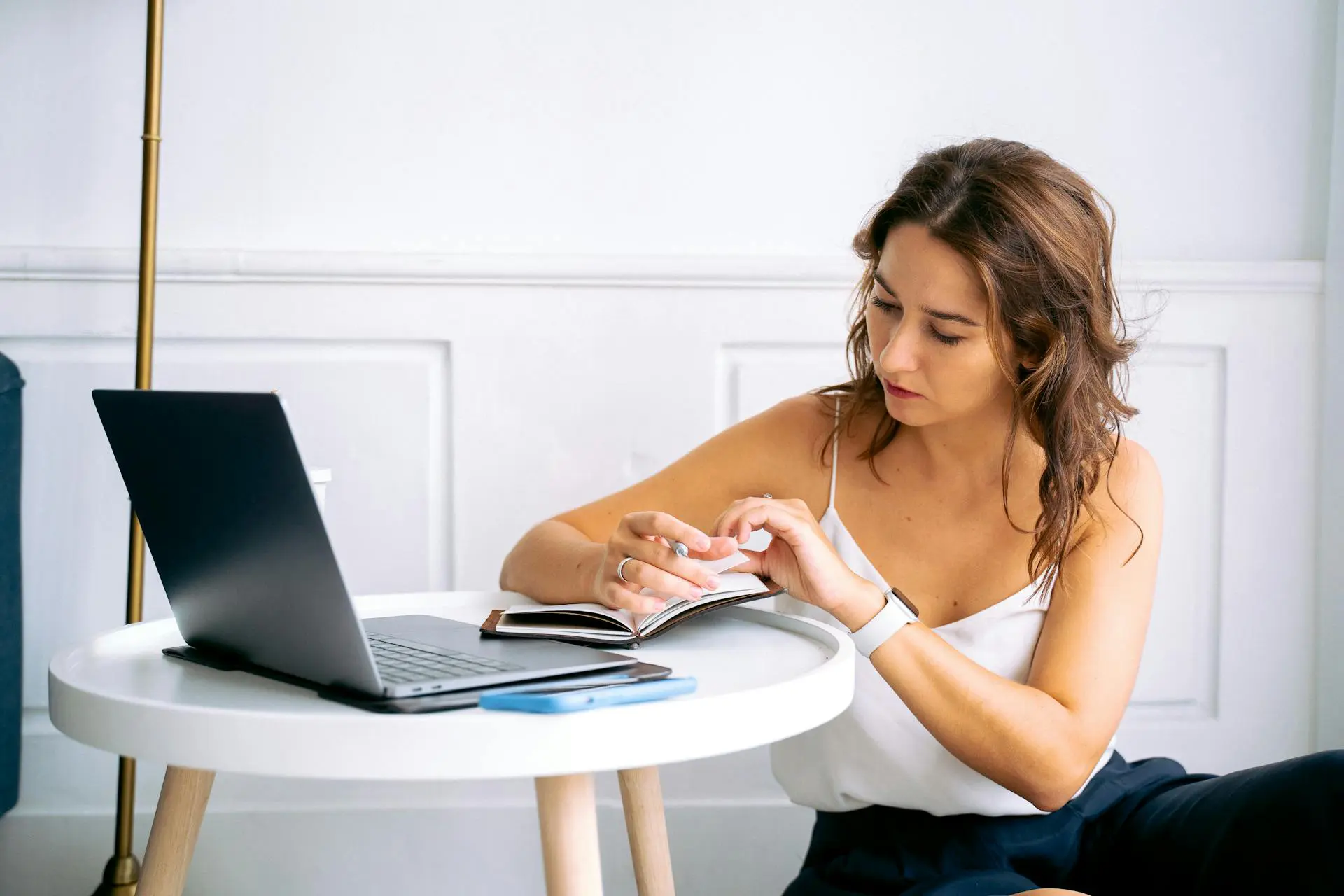 Woman studying with laptop and notepad