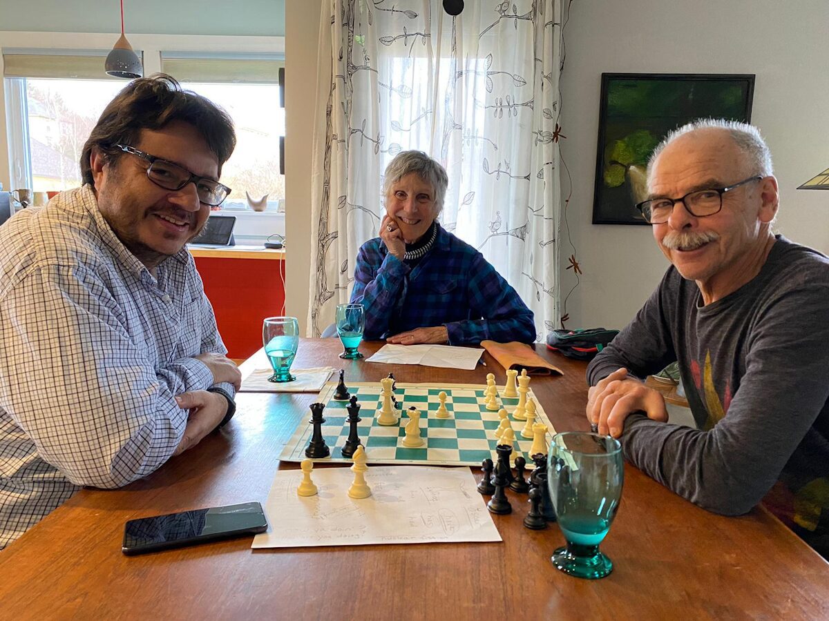 ACLA Language Exchange program example of three people playing chess